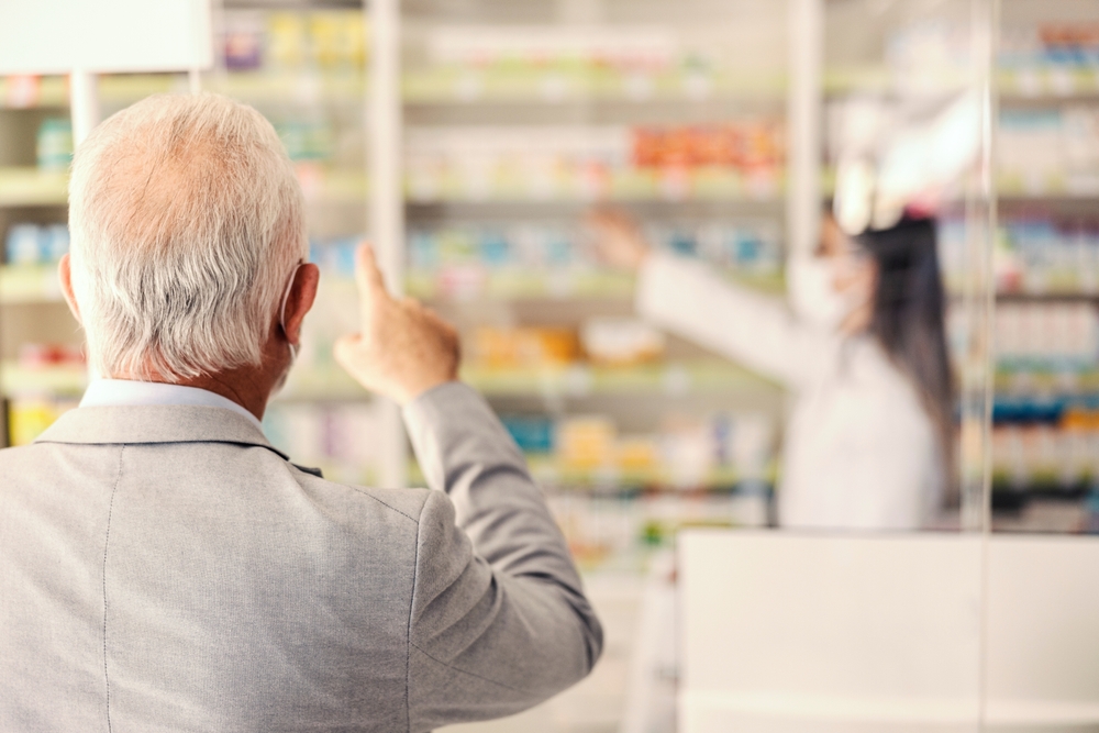 Pharmacy laser labels printing through laser printer at Vancouver BC dispensary counter