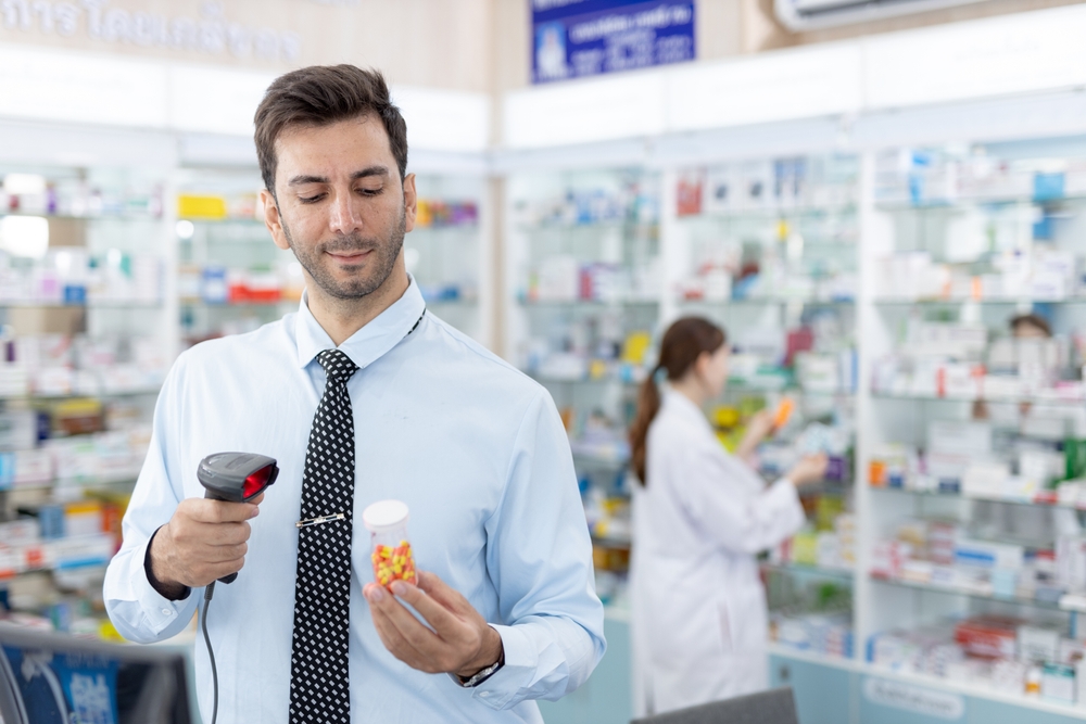 Independent BC pharmacist printing prescription labels at dispensary counter